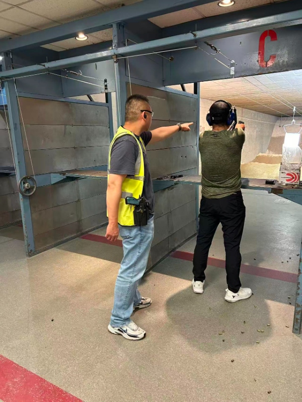 Instructor coaching student at shooting range
